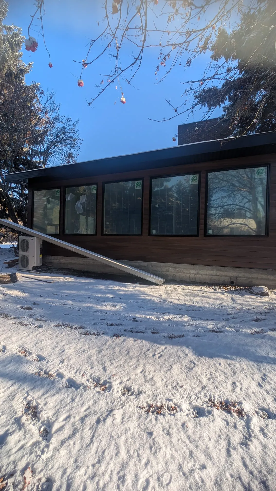 ACR Construction long wall of windows with modern dark siding and fascia