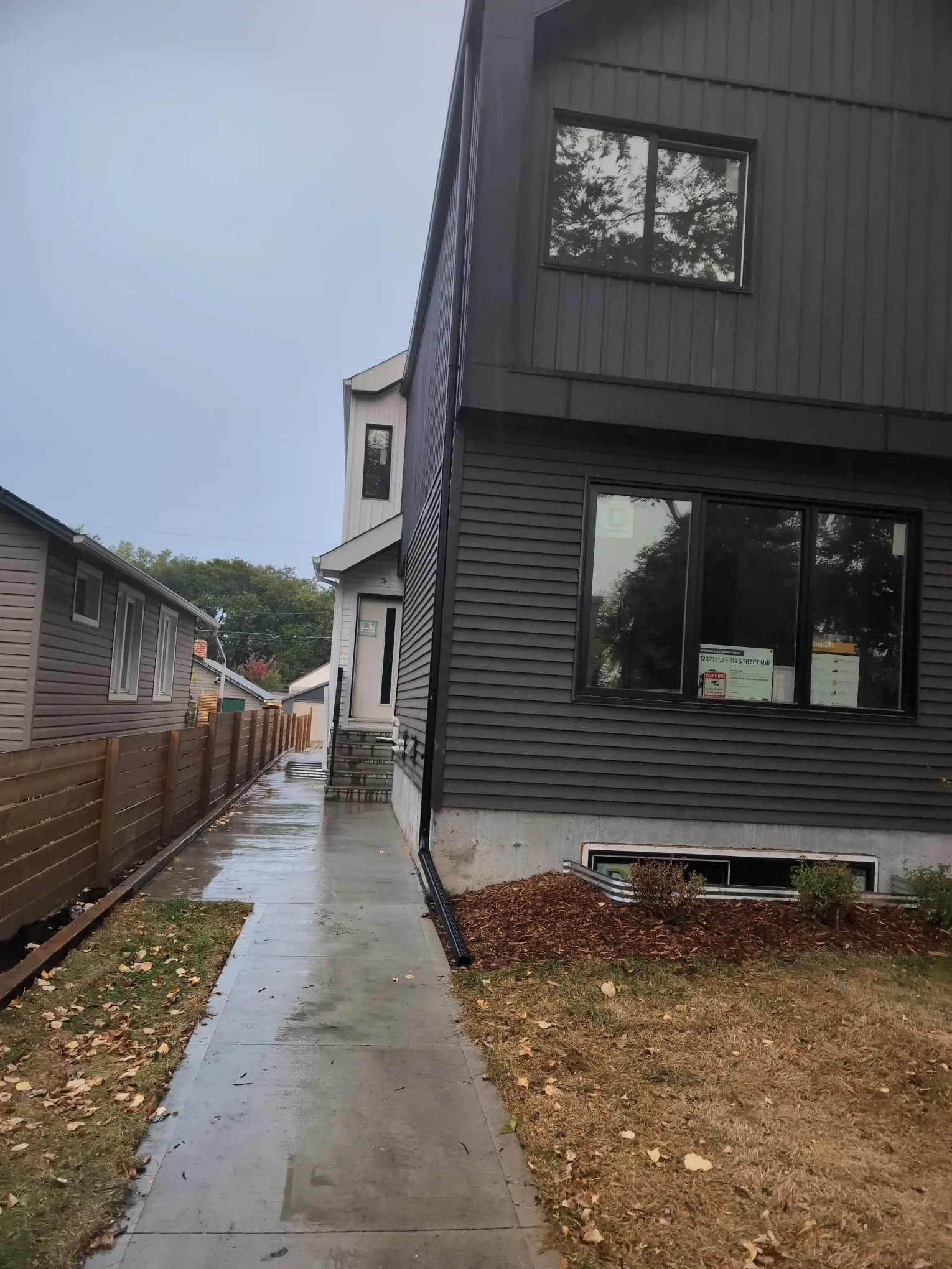 ACR Construction dark grey siding with downspout and gutter installation