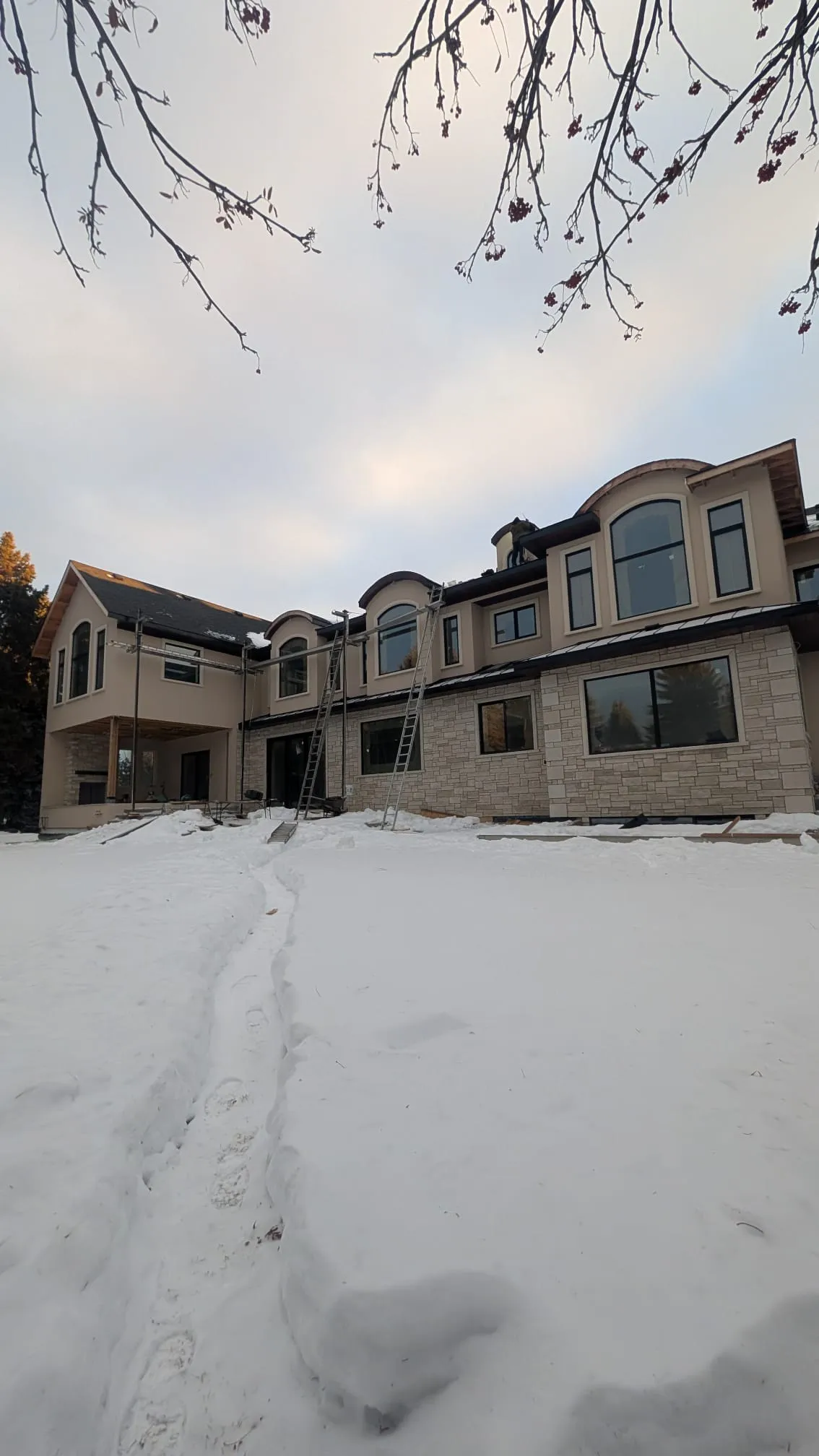 ACR Construction wide view of luxury stone and stucco home in Edmonton winter