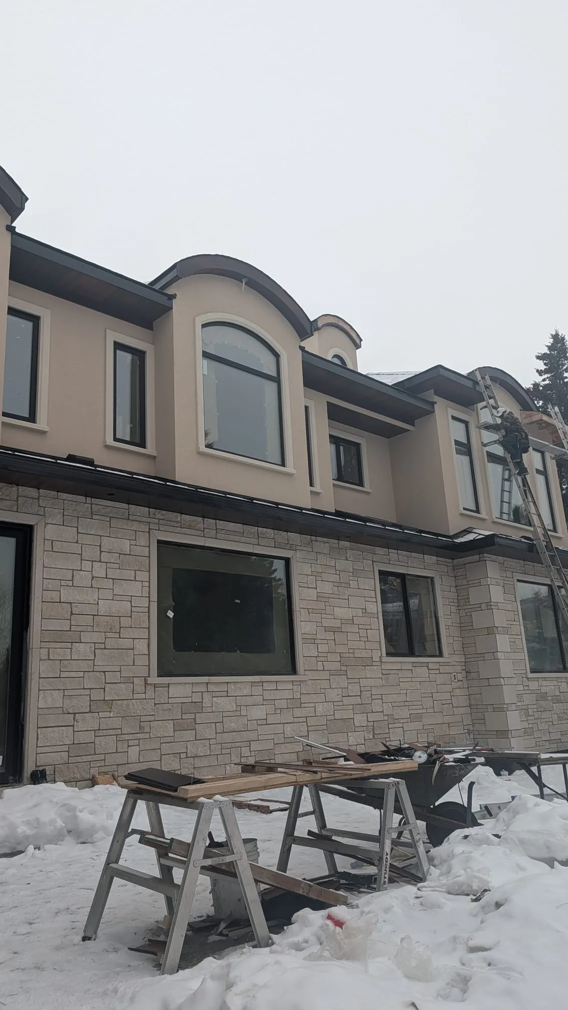 ACR Construction stone and stucco facade with arched windows