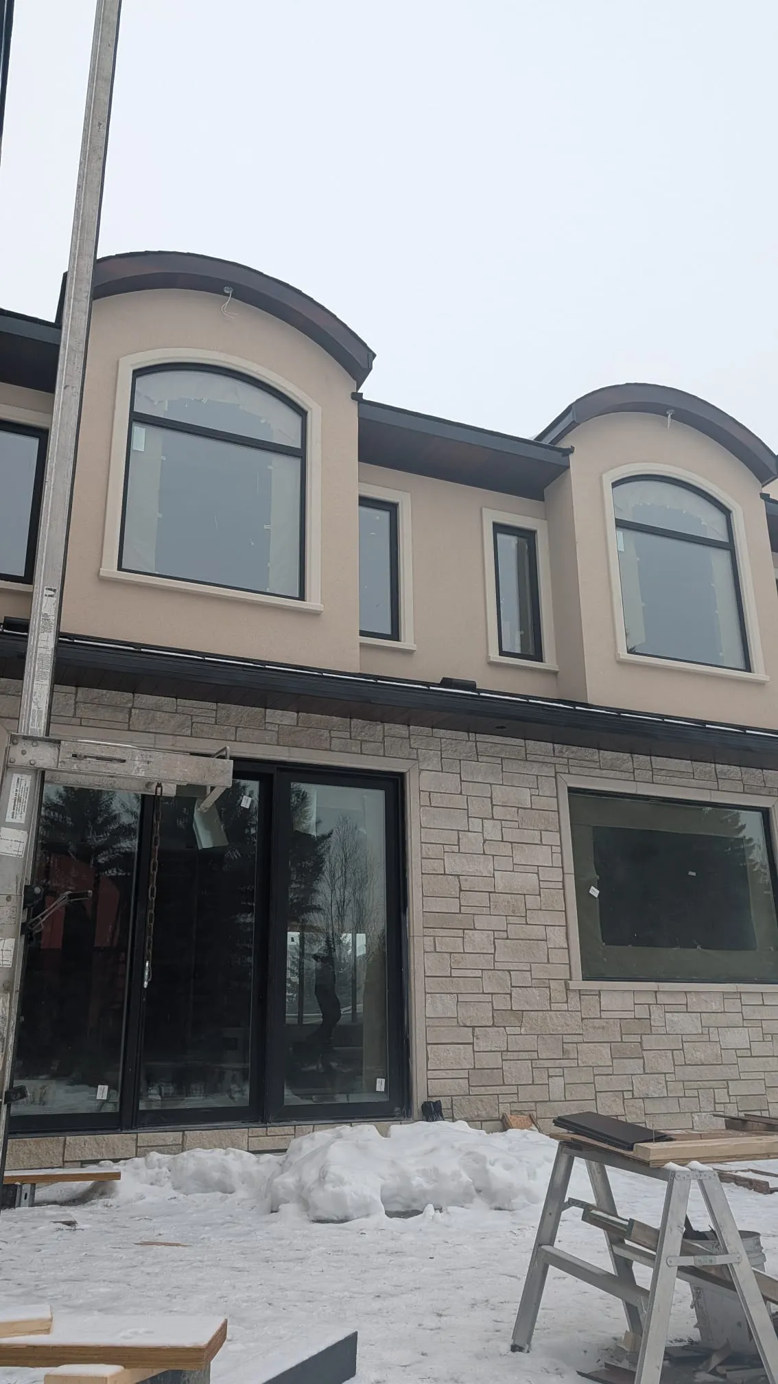 ACR Construction stone wall detail with patio doors and arched windows above